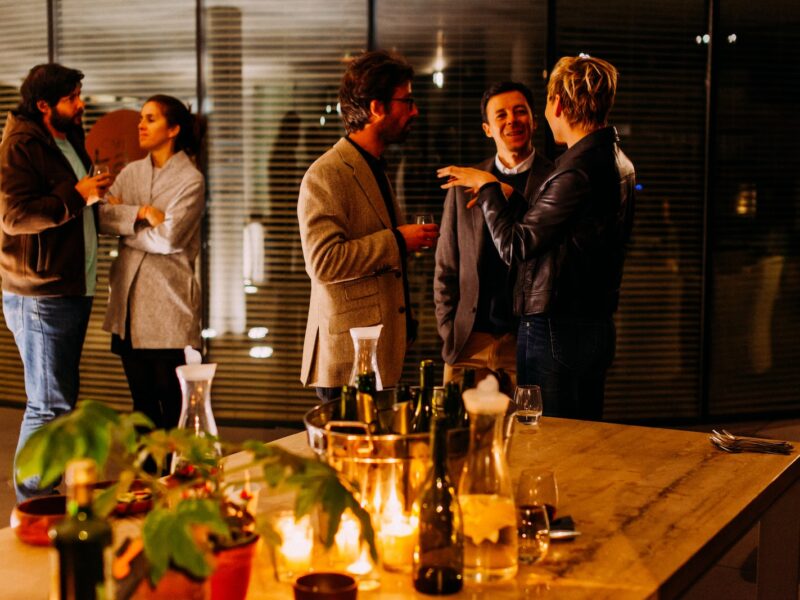 five person standing while talking each other
