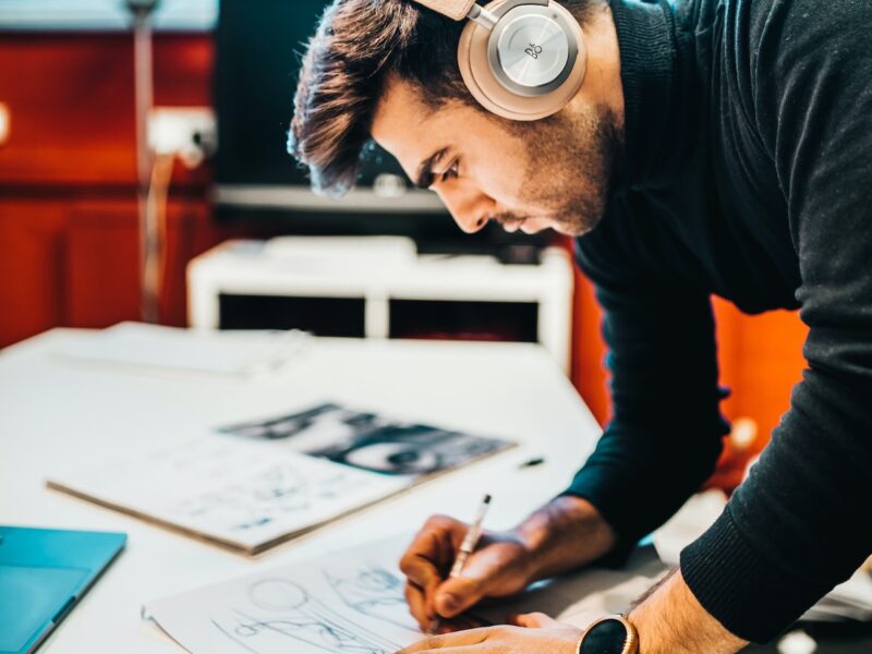 man wearing headset drawing