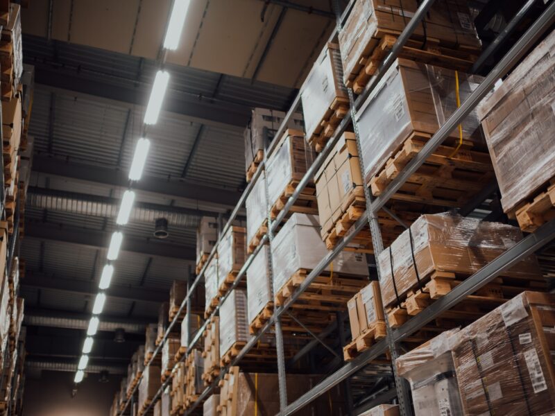 brown cardboard boxes on white metal rack