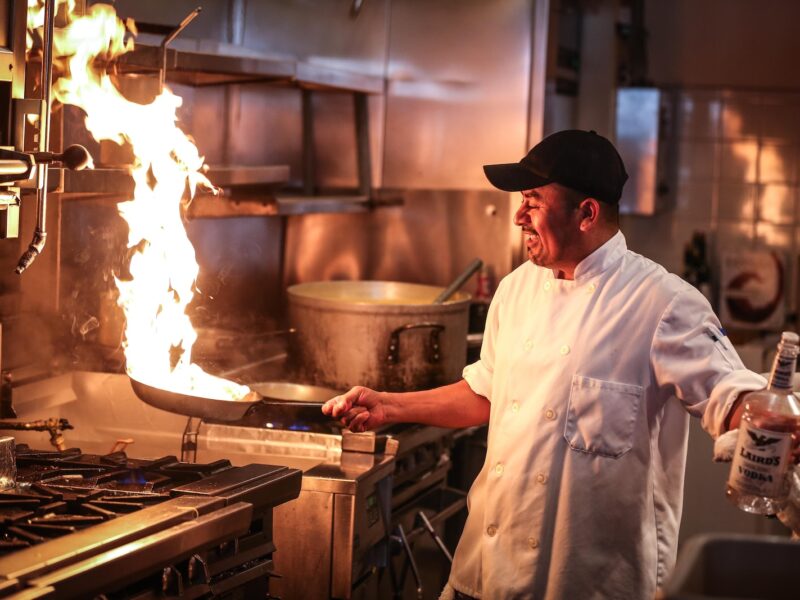 man in white chef uniform cooking