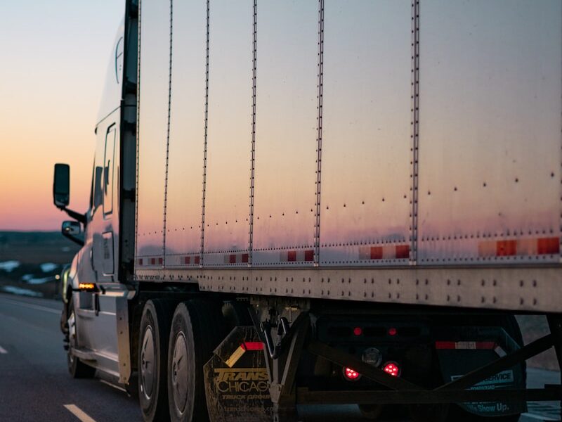 white freight truck on road during daytime