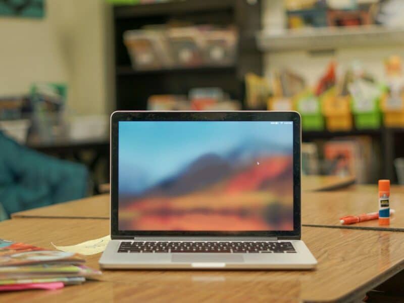 macbook pro on brown wooden table